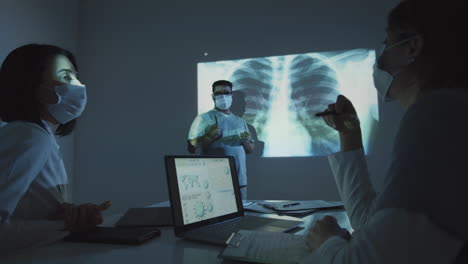 Female-Doctors-Discussing-Chest-X-Ray-with-Male-Colleague